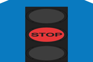 Eine Ampel mit rotem Haltesignal vor einem blauen Hintergrund.